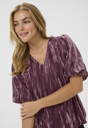 Plush, deep purple blouse with a V-neck, short puff sleeves, and a textured fabric featuring vertical stripes. Soft and relaxed fit.