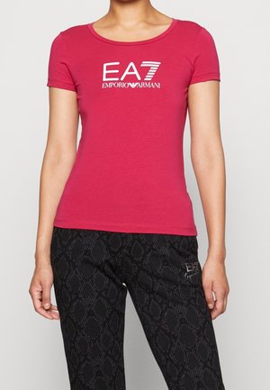 Fitted pink cotton t-shirt with short sleeves and a round neckline. Features white EA7 Emporio Armani logo across the chest.