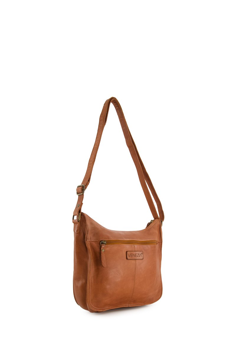 Brown leather shoulder bag with adjustable strap, zipper pocket on front, rounded shape, and a debossed logo on the side.