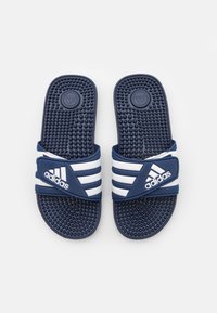 Navy blue rubber slides with three white stripes, textured footbed, and Adidas logo on the band. Lightweight, simple design, open-toe style.