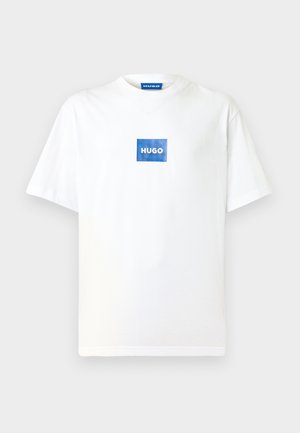 Witte katoenen T-shirt met korte mouwen en een ronde hals. Heeft een blauw rechthoekig logo met "HUGO" gecentreerd aan de voorkant.