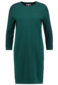 Grünes Strickkleid mit langen Ärmeln, Rundhalsausschnitt und marineblauen Akzenten an den Schultern. Verfügt über einen geraden Schnitt und ein kleines Logo auf der Brust.