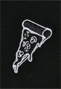 Black fabric features a white embroidered design of a pizza slice, emphasizing texture and detail in the cheese and toppings.