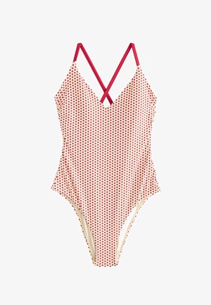 Jednodielne plavky s červenými bodkami na krémovej látke a prekríženými červenými ramienkami.