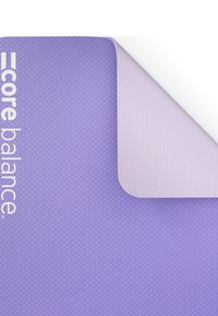Tappetino da esercizio viola con superficie texturizzata e bordo liscio. Presenta il marchio "core balance" in bianco su un lato.
