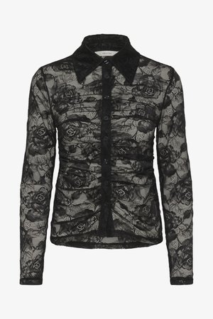 Blouse en dentelle noire avec des manches longues, un col et un devant à boutons. Présente des motifs floraux et des détails texturés dans l'ensemble.