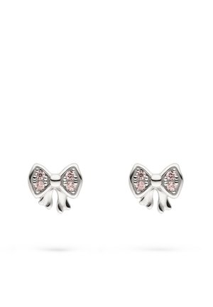 Pair of silver bow-shaped stud earrings with three small pink gemstones on each bow's loops against white background.