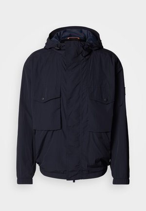 Navy blue lightweight jacket with a hood, two flap pockets, and elastic cuffs. Made of soft, textured fabric with a relaxed fit.