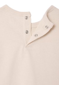 Beige cotton shirt collar with a two-button closure at the back, featuring a soft texture and ribbed trim.