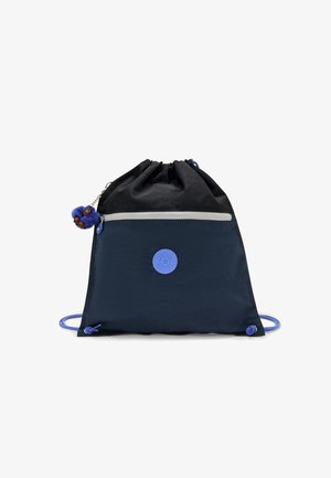 Sac à dos à cordon noir et bleu marine avec poche zippée à l'avant, logo circulaire et porte-clés en forme de singe bleu accroché à la tirette de la fermeture.
