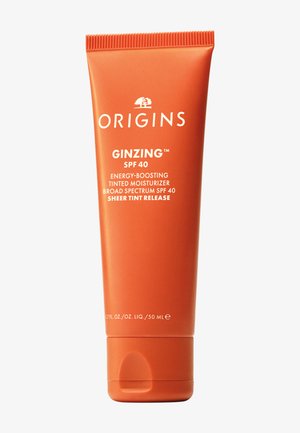 Orangefarbene Tube Origins GinZing SPF 40 energieverstärkende getönte Feuchtigkeitscreme mit Breitbandschutz, 50 ml.