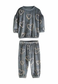 Velvet loungewear set featuring a gray top with puffed sleeves and gold heart patterns, paired with matching pants with elastic cuffs.