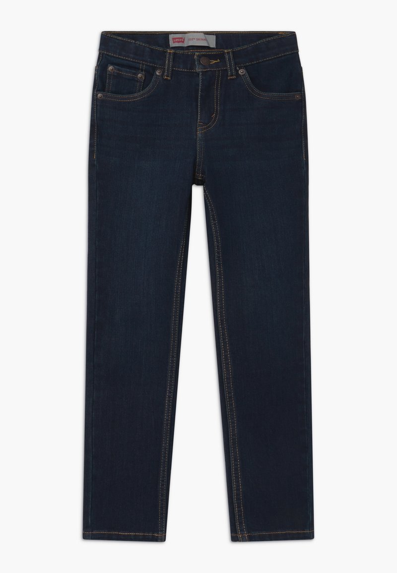Jean skinny indigo foncé avec design cinq poches, fermeture par bouton et zipper, et coutures contrastées, posé à plat sur fond blanc.
