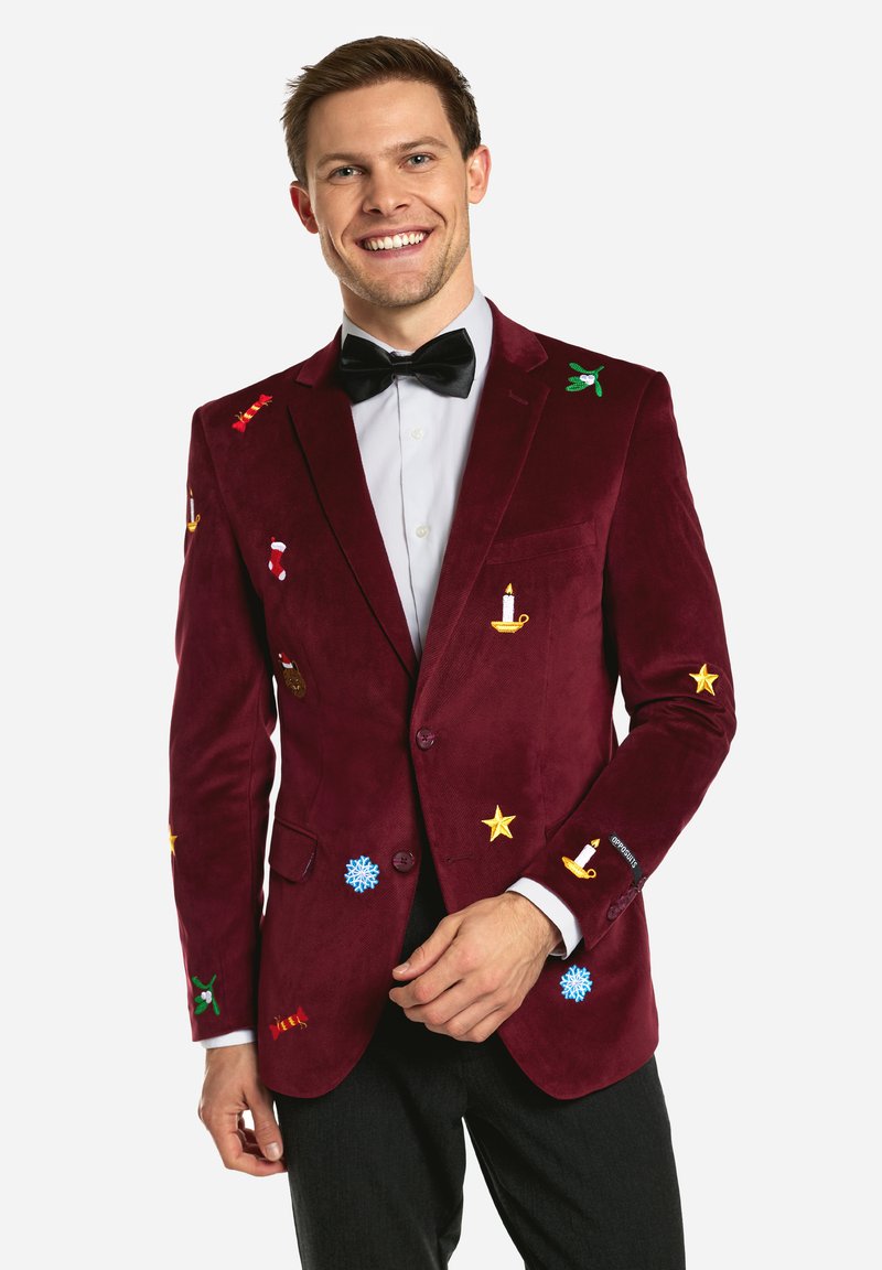 Burgundy velvet blazer with colorful embroidered holiday motifs, including stars, candy canes, and candles, paired with a black bow tie.