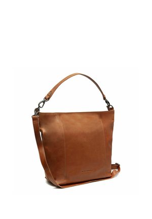 Borsa tote in pelle marrone con due spallacci regolabili e cuciture minime, in piedi su uno sfondo bianco.