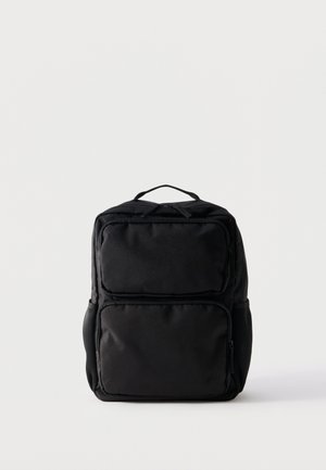 Black rectangular backpack with two front zippered compartments and a top carry handle on a plain white background.