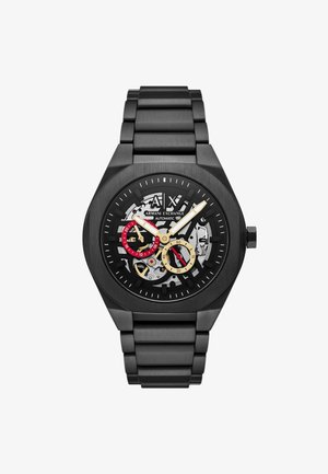 Orologio automatico nero con bracciale in acciaio inossidabile. Il quadrante a scheletro presenta accenti in oro e rosso. Indicatori delle ore audaci, design minimalista.