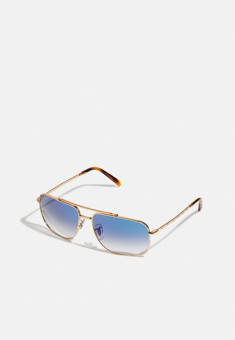 Occhiali da sole in metallo dorato con lenti blu sfumate, forma rettangolare, fine decorazione sulla montatura e accenti in tartaruga sulle tempie.