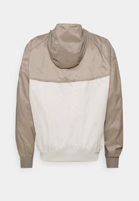 Nike Sportswear Corta-vento - light bone/moon fossil/lemon twist/black