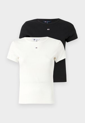 Two short-sleeve t-shirts stacked, one black and one white, featuring a ribbed texture and a small logo on the chest.