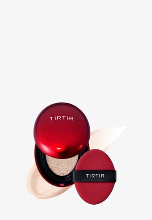 Red circular compact with "TIRTIR" logo, containing a sponge applicator. Visible foundation cream in a creamy beige shade. Textured surface.
