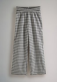Fekete-fehér kockás mintázatú, bő szárú nadrág, rugalmas derekkal, könnyű anyagból, laza szabású.
