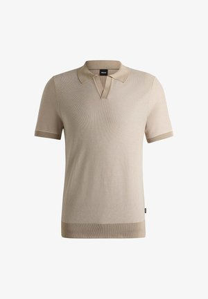 Beige kortermet polo-skjorte med en teksturert mønster, åpen krage og kontrastfargede ribbede detaljer på ermene og hem.