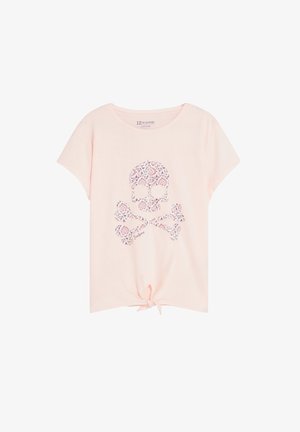T-shirt rose clair à manches courtes avec un motif de crâne floral et os croisés sur le devant et un petit nœud noué au centre du bas.