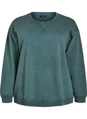 Oversized green sweatshirt made of soft cotton fabric. Features a crew neckline, ribbed cuffs, and hem with subtle stitching details.