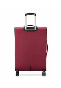 Red soft-sided suitcase with black wheels, a black handle, and a silver telescoping pull handle extended upright.