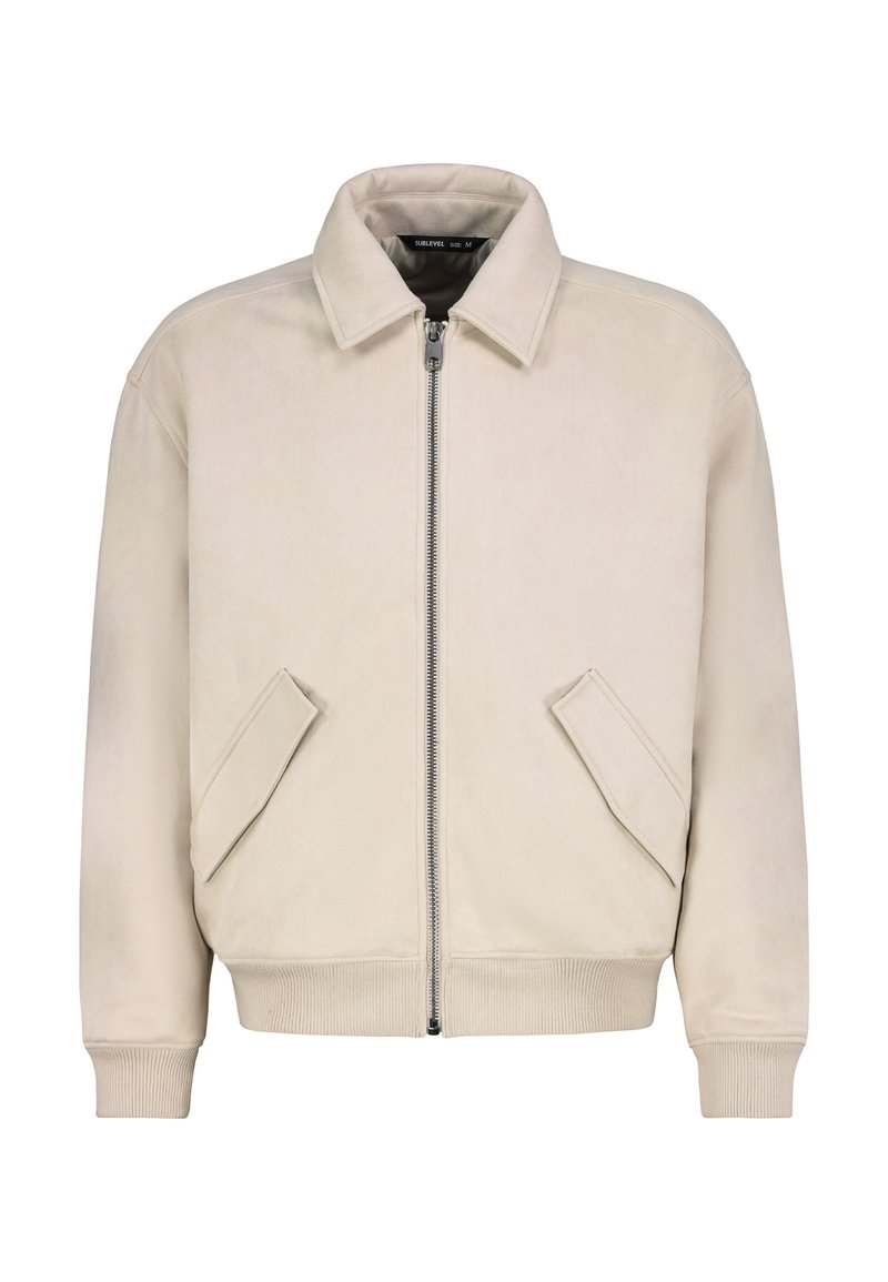 Beige Bomberjacke aus weichem Stoff mit Reißverschluss, Kragen und zwei schrägen Seitentaschen. Gerippte Bündchen und Saum.