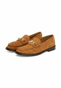 Brown suede loafers with a textured surface, featuring a gold-tone chain detail across the vamp and a black rubber sole.