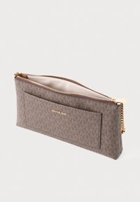 Rectangular brown Michael Kors pouch with repeating logo pattern, gold zipper, front slip pocket, and light beige interior lining.
