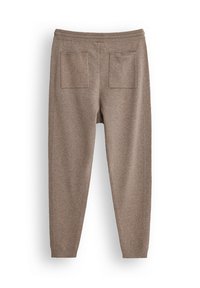 Brązowe dzianinowe spodnie dresowe o tapered designie, z elastycznym paskiem w talii oraz dwiema tylnymi kieszeniami naszytymi. Miękka faktura z gładkim wykończeniem.