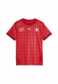Punane jalgpallipaita koos tekstureeritud mustriga ja tumepunaste aktsentidega. Tunnused hõlmavad ümarat kaelust, logo ja Šveitsi lipu embleemi rinnal.