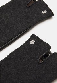 Black felt gloves with leather accents, featuring cut-out finger sections and a small emblem on each glove. Textured, sleek design.