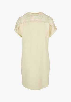 Žuta haljina kratkih rukava s čipkastim gornjim dijelom na leđima. Tkanina je glatka, s okruglim izrezom i blagim zakrivljenjem na rubu.