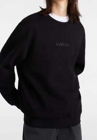 Černá mikina z bavlněné směsi s kulatým výstřihem a žebrovanými manžetami. Jemně vyražené logo "vans." na hrudi.
