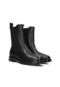 Zwarte leren enkelboots met elastische zijkanten en een gestructureerde afwerking. Stevige rubberen zolen met een slanke, taps toelopende vorm.