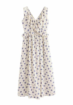 Sleeveless cream maxi dress with blue floral print, V-neckline, and ruffle details on bust and waist.