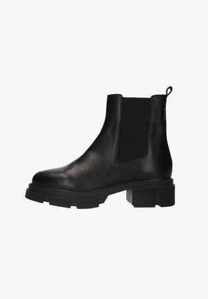 Botte cheville en cuir noir avec panneaux latéraux élastiques, bout arrondi, semelle texturée épaisse, et une languette à l'arrière pour un enfilage facile.