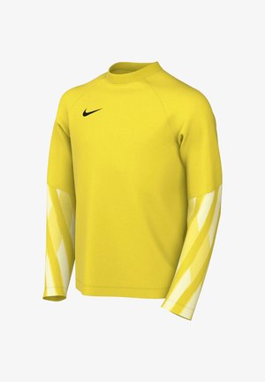 Camiseta deportiva amarilla de manga larga con cuello acanalado, logo de Nike en el pecho y patrones diagonales a rayas amarillas y blancas en las mangas.