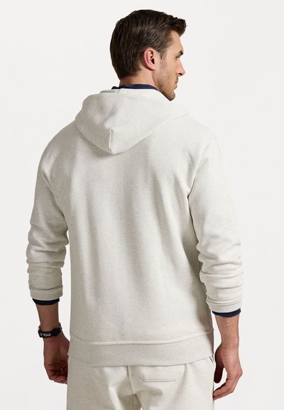 Light gray hoodie with a textured finish, adjustable hood, and ribbed cuffs. Includes a subtle logo accent on the wrist.