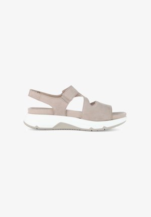 Beige open-toe sandaal met verstelbare bandjes, een gevoerd voetbed en een dikke witte zool, ontworpen voor comfort en casual gebruik.
