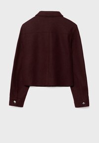 Burgundy wool jacket with a collared neckline, cropped design, and buttoned cuffs. Smooth texture with a minimalist style and no visible hardware.