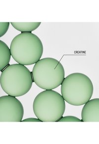 Molécules sphériques vertes reliées par des liens fins, avec l'étiquette « CREATINE » pointant vers une des sphères, sur fond blanc.