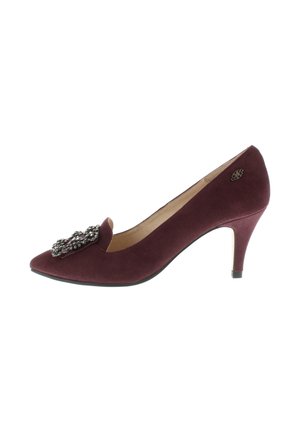 Burgundy suede mid-heel pump with pointed toe and decorative jeweled brooch on the front and small metal logo on the side.