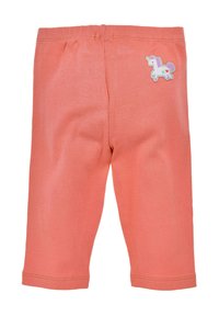 Leggings de couleur corail en tissu coton extensible, avec un petit appliqué de licorne sur l'arrière droit. Conçus pour le confort et la mobilité.