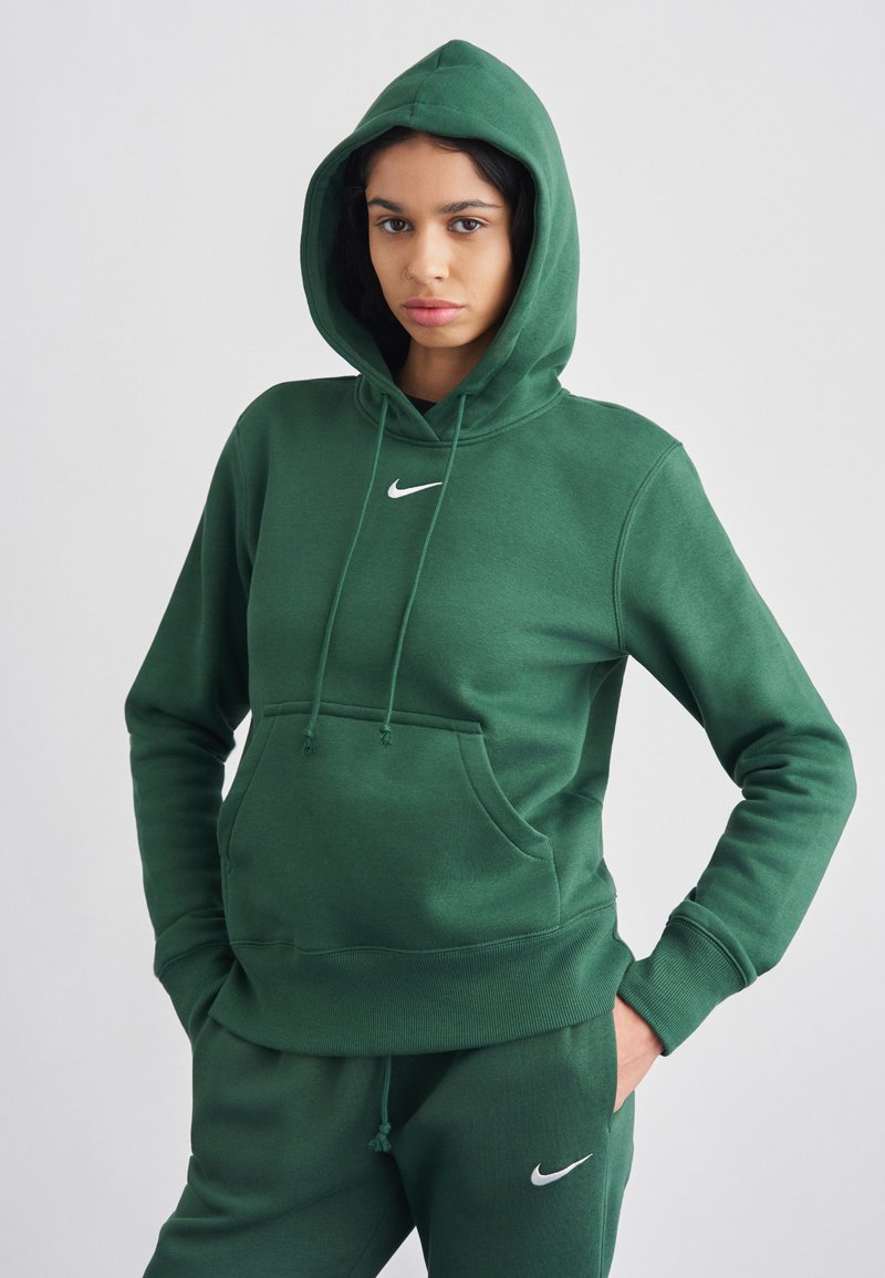Sweatshirt verde com capuz e bolso frontal. Apresenta logótipo branco da Nike no peito. Feito em tecido macio com punhos e bainha canelados.