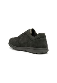 Zapatillas de ante negro con un perfil bajo, punta redondeada, cordones finos y acentos texturizados. Suela de goma gruesa con detalles de tracción.